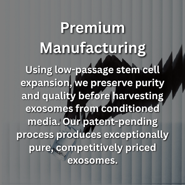 Hand grasping a Resiliélle Age Zero™ Exosome vial with vertical blinds in the background. Premium Manufacturing — Using low-passage stem cell expansion to preserve purity and quality before harvesting exosomes through a patent-pending production process.